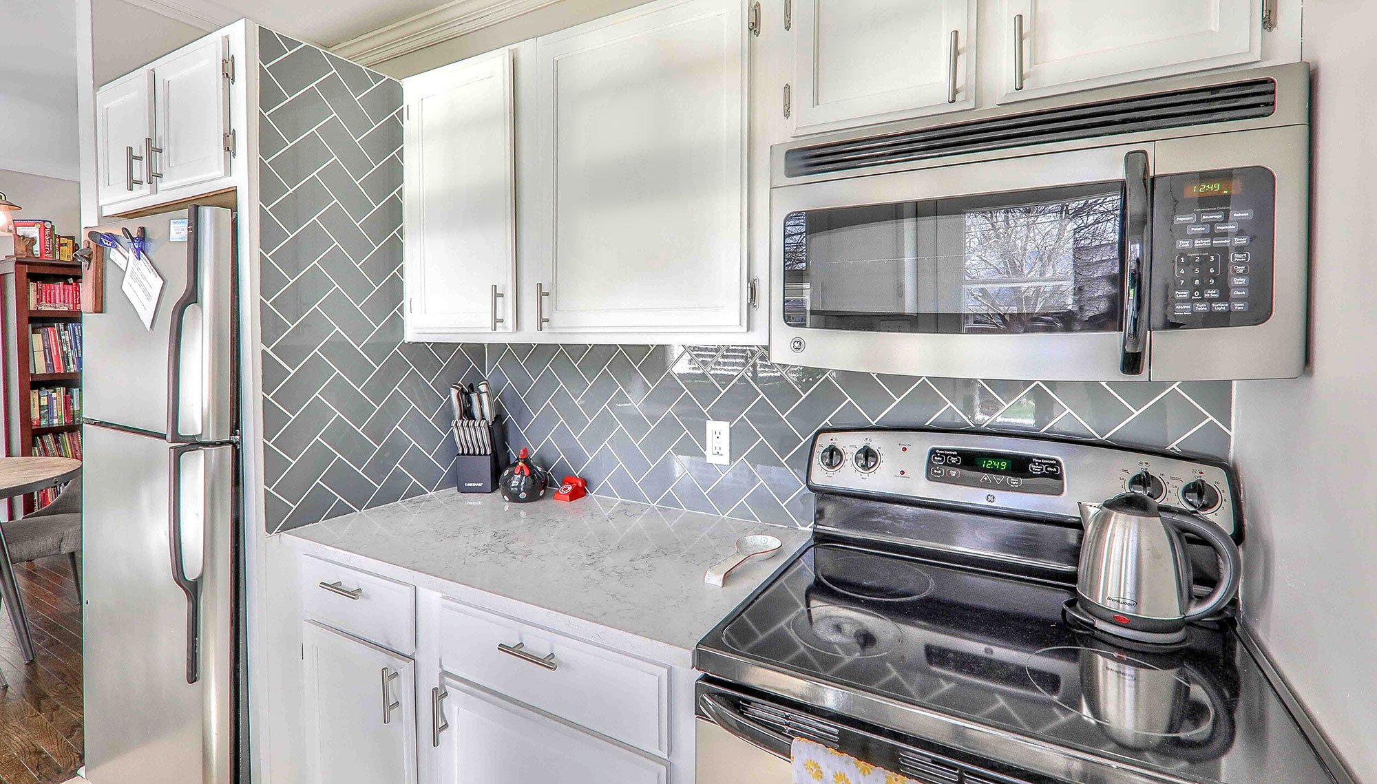 kitchen with gray tile wall panel backsplash